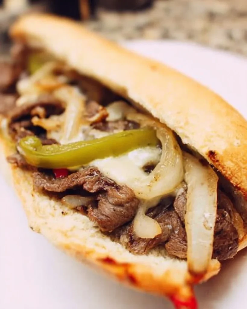 Delicious homemade Philly Cheesesteak sandwich with melted cheese and peppers