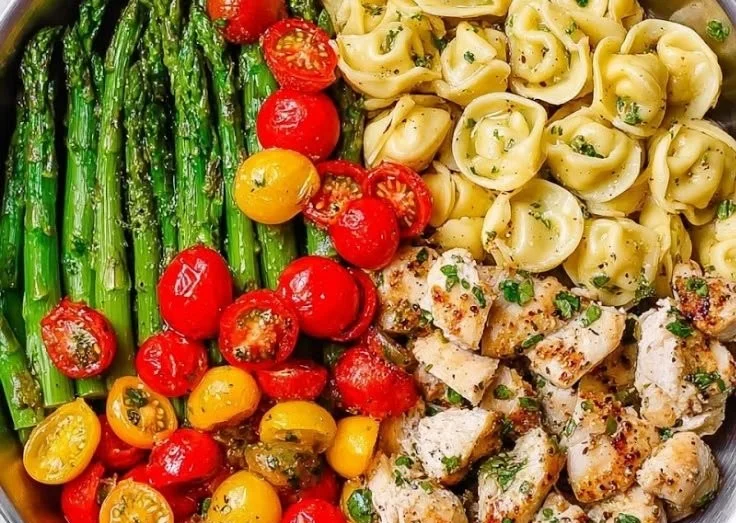 Creamy Pesto Chicken Tortellini served in a bowl with fresh basil